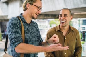 Two men talk animatedly with one another